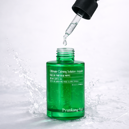Green bottle of Pyunkang Yul Ultimate Calming Solution Ampoule with dropper on a white background