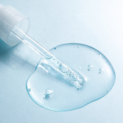 Skincare dropper with clear gel on a light blue background