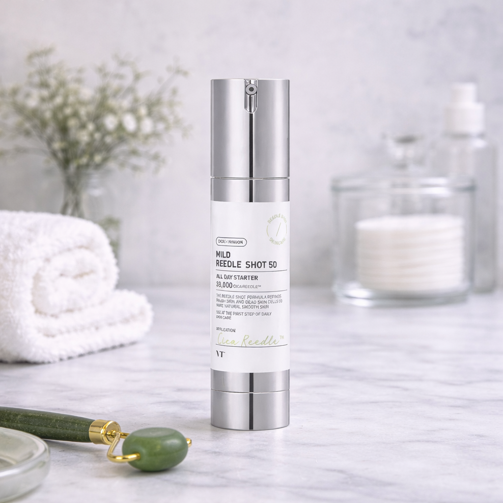 Skincare bottle on a marble surface with a white towel and decorative items in the background